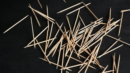 bamboo toothpicks on a black background - Powered by Adobe