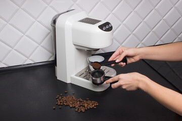 woman make espresso on white espresso coffee machine on kitchen