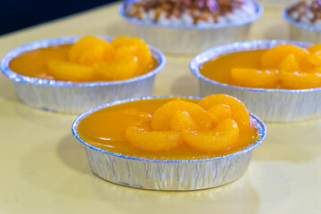 Rows of orange cake with orange topping