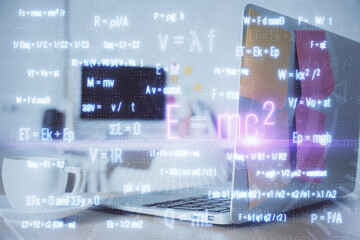 Desktop computer background and formula hologram writing. Double exposure. Education concept.