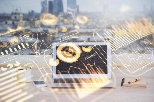 Computer on desktop in office with technology theme hologram. Multi exposure. Tech concept.