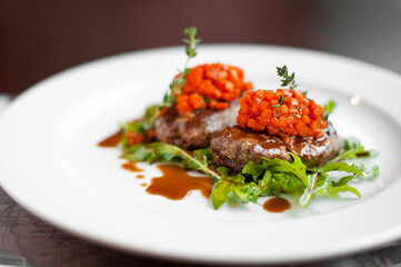 Meat steak with pumpkin and arugula. Dish at the restaurant