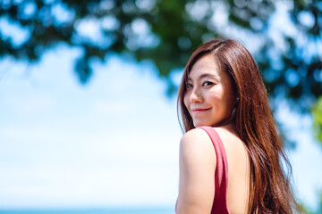 A beautiful young asian woman and the blue sky background