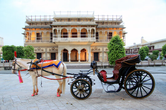 Jaipur,Rajasthan,India - November,2018 : Beautiful evening view of famous City Palace of Jaipur. Horse cart standing in front cloak gallery. 