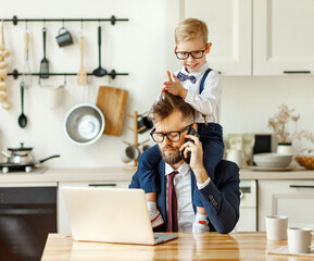 Modern busy man working remotely at home with playful kid.