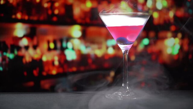 cocktail in a martini glass on bar background.