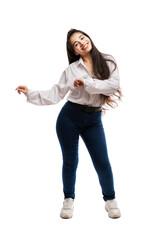 A young girl in jeans and a white shirt laughs and dances. Brunette with long hair. Positive and emotions. Full height. Isolated on a white background. Vertical.