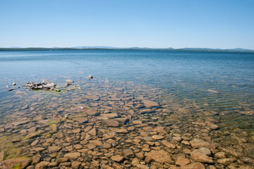 Landscape view of Uvildy lake with its rocky bottom and clear water, South Urals, Russia
