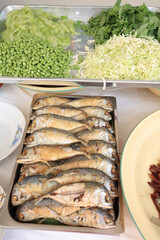 Group of fried mackerel fish and vegetable in restaurant