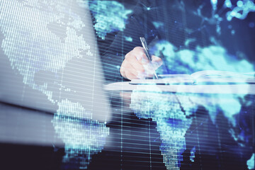 Double exposure of hands and notepad with business icons.