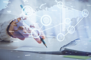 Social network theme hologram over woman's hands writing background. Concept of international people connect. Double exposure