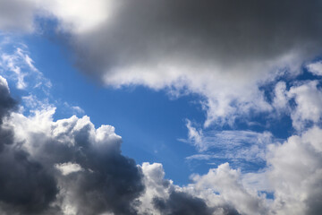 Background of grey storm clouds in a dark blue sky