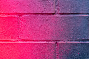 Beautiful bricks colorful street art graffiti background. Abstract gradient spray drawing fashion colors on the brick walls of the city. Urban  orange , pink , purple , crimson, blue texture