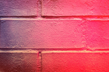 Beautiful bricks colorful street art graffiti background. Abstract gradient spray drawing fashion colors on the brick walls of the city. Urban  orange , pink , purple , crimson, blue texture