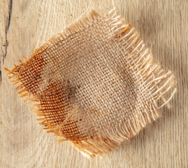Burlap fabric on a wooden background.