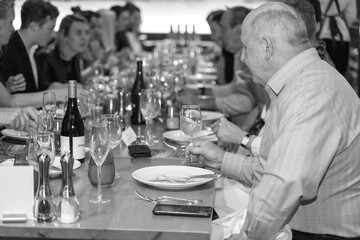 man in a restaurant function enjoying a glass of wine