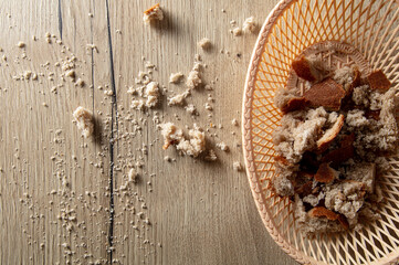 Bread crumbs on a wooden table.