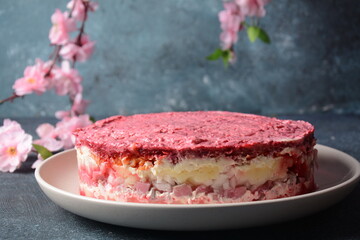 Layered salad with herring, beets, carrots, onions, potatoes and eggs. 