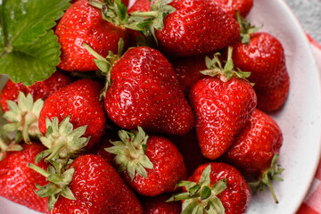 Beautiful juicy fresh strawberries on the concrete surface of the table