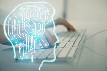 Businessman with computer background with brain theme hologram. Concept of brainstorm. Multi...
