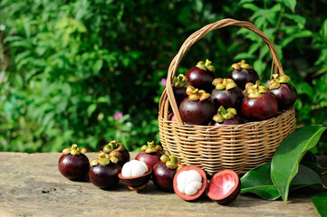 Mangosteen in a basket placed on wooden, Queen of fruit in Thailand.