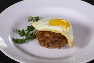 Beef cutlet with egg and coriander