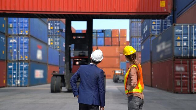 Engineer woman with Business man control loading Container from Cargo freight ship for import and export , support logistics transportation concept.