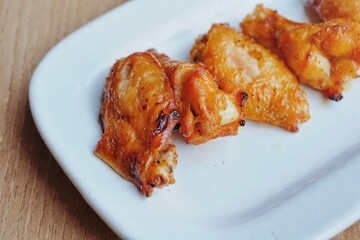 Chicken wings on a white plate.