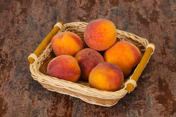 Peach heap in the wooden basket