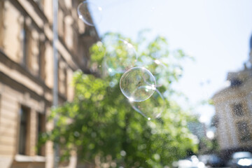 Soap bubbles in the air exploding with spray
