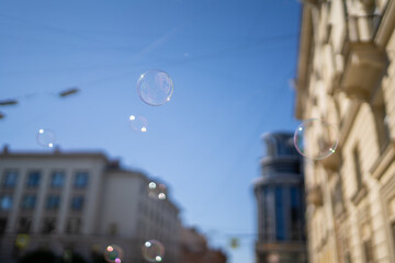 Soap bubbles in the air in the city