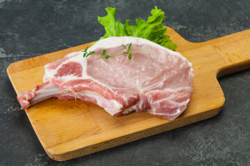 Raw pork bone steak over wooden