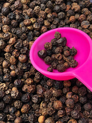 Black pepper in a plastic spoon