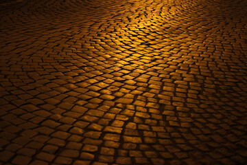 Golden night light on the street cobblestones