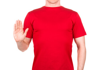 Man in red t-shirt showing stop sign or warning gesture isolated on white