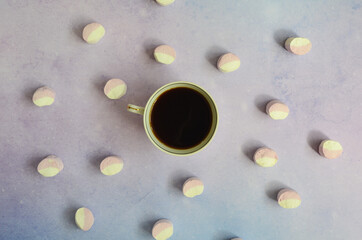 Cup of coffee and marshmallow top view. The concept of breakfast and the morning. Flat lay and minimalism