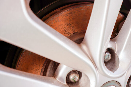 Old Rusty On Front Wheel Disc Brake Of The Car Due To Not Usage And Parking For Long Time ,automobile Part And Maintenance Concept ,selective Focus On The Rusty