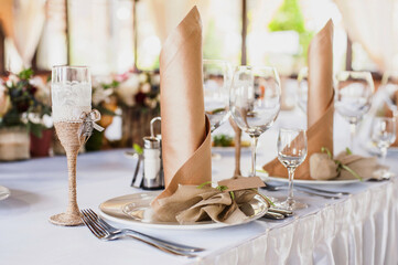 Beautiful decorated table set for wedding party. Old-fashioned wedding decorations with flowers. Rustic retro classical style	