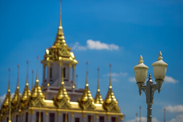 Background of tourist attractions where people come to see the beauty of the architecture of the golden pagoda in Bangkok (Wat Metal Prasat Or Wat Ratchanaddaram Worawihan) in Thailand