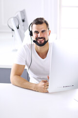 Businessman in the office on the phone with headset, Skype