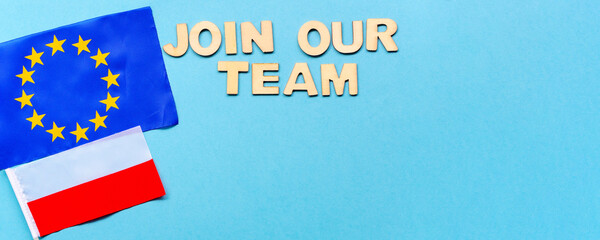 Search for employees, recruitment after crisis and coronavirus. join our team-wooden letters on blue background. flatly with copy space. new hiring positions. EU and Polish flags,work abroad