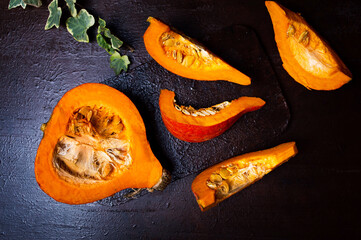Fresh opened pumpkin on a dark table