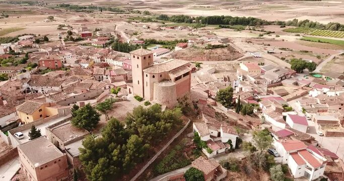 View from drone of Cervera de la Canada cityscape overlooking fortified Catholic church of Iglesia de Santa Tecla, Spain