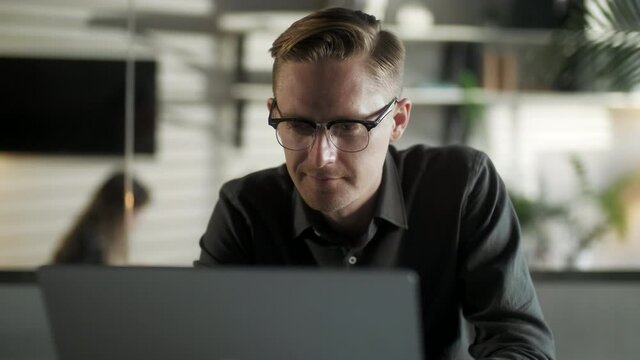 Young Man Freelancer Using Laptop Online Working From Office In Internet, Smiling Focused Millennial Guy Searching On Computer Surfing Web Looking At Screen Enjoying Distant Job