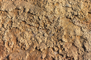 Texture of different layers of clay on the edge of a cliff. Closeup