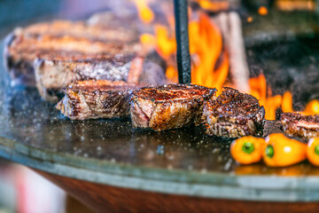 Grilling steaks on flaming grill.Beef steaks on grill.Grilling steak on BBQ.