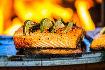 Grilled salmon fish fillet with fresh lemon on wooden table
