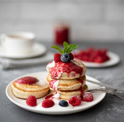 pancakes with raspberry jam, sour cream and powdered sugar