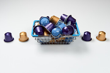 Caffeine, hot drinks and objects concept. Close up blue, purple and golden capsules or pods for...