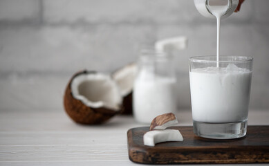 coconut milk in a glass bowl with chopped coconut